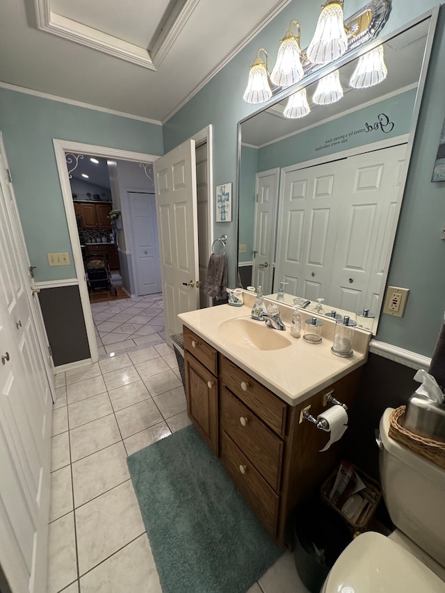 bathroom featuring crown molding, vanity, a tray ceiling, tile patterned floors, and toilet