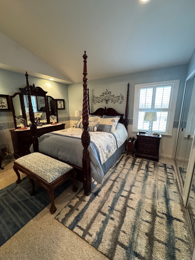 carpeted bedroom with lofted ceiling