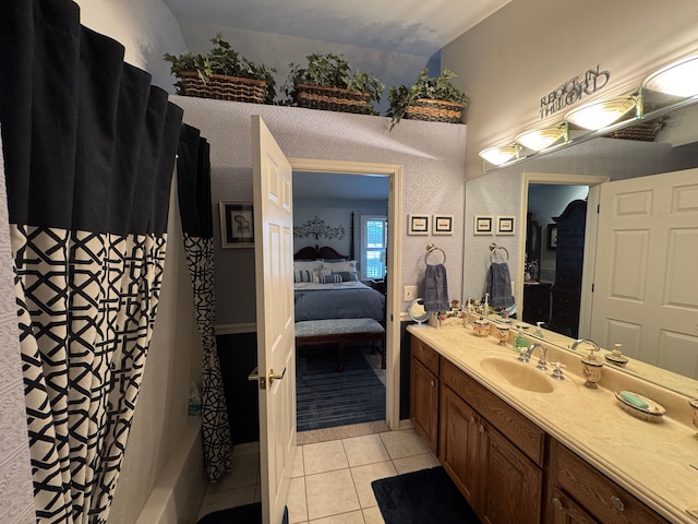 bathroom featuring tile patterned flooring, vanity, and shower / bath combo with shower curtain