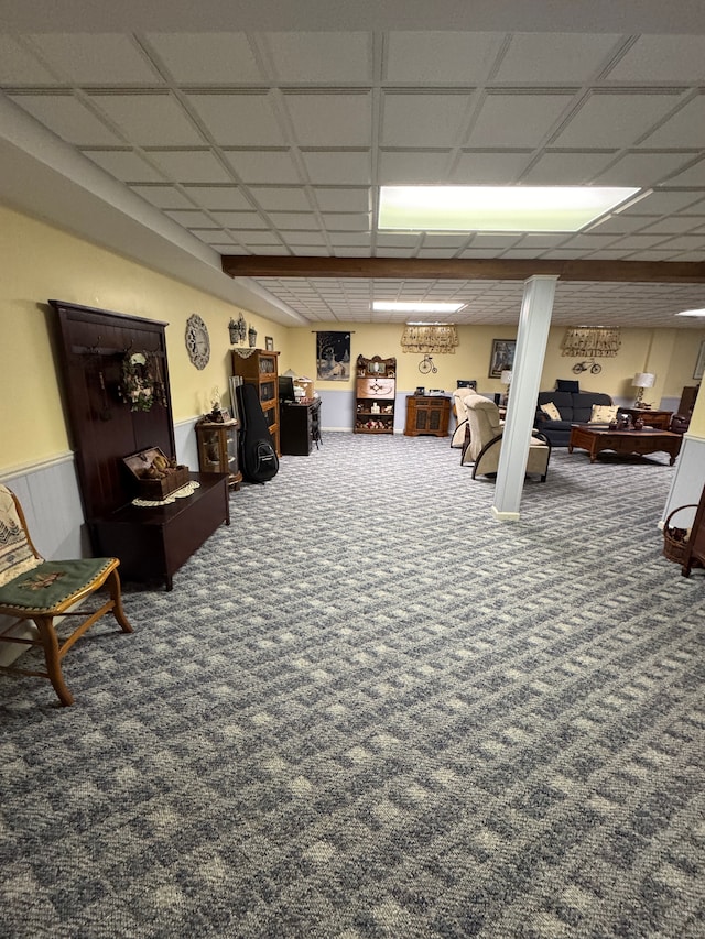 living room with a paneled ceiling and carpet flooring