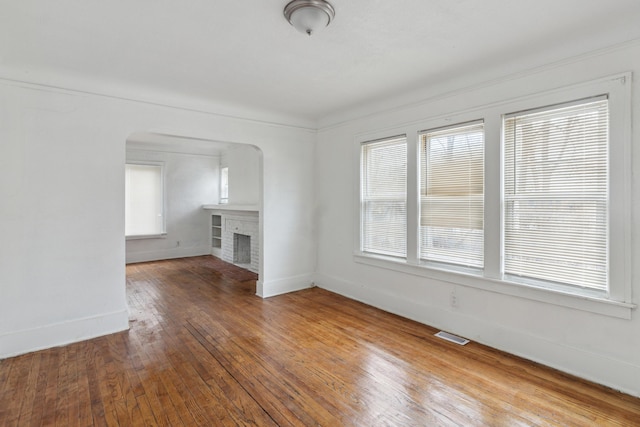 unfurnished living room featuring hardwood / wood-style floors and a fireplace