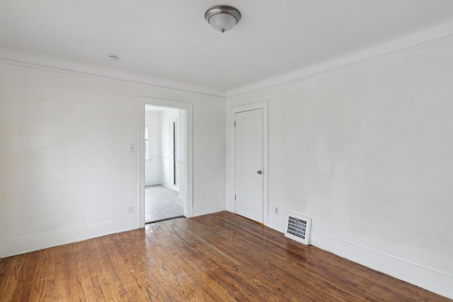 unfurnished room featuring hardwood / wood-style flooring and crown molding