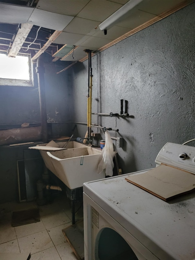 washroom with washer / dryer and sink