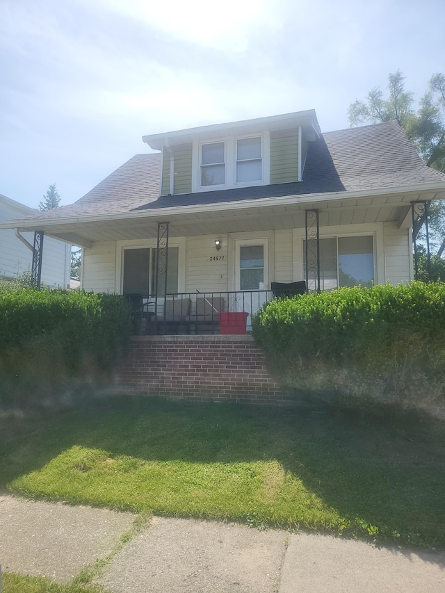 view of front of home with a front lawn and a porch