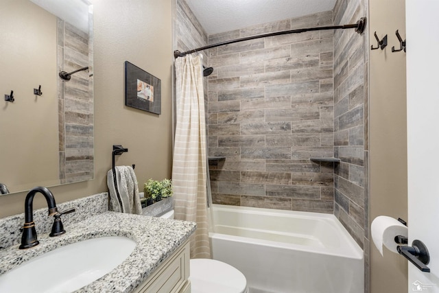 full bathroom with shower / bath combination with curtain, vanity, toilet, and a textured ceiling