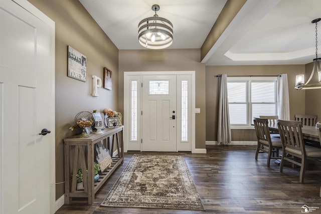 entrance foyer featuring dark hardwood / wood-style flooring and a notable chandelier