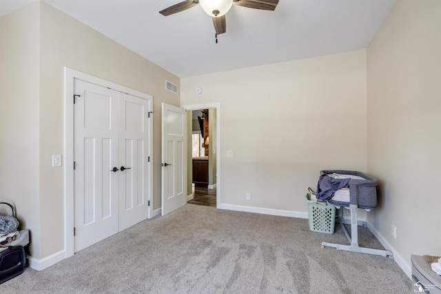 unfurnished bedroom with ceiling fan, a closet, and light carpet