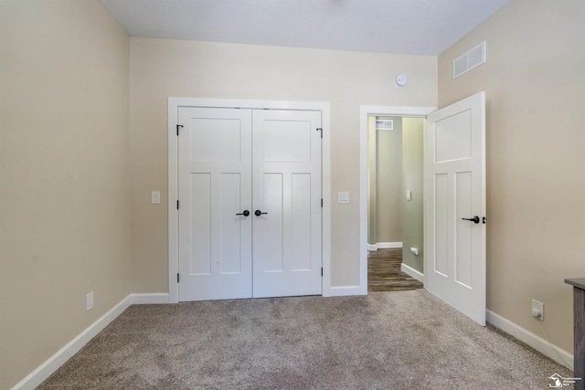 unfurnished bedroom featuring carpet and a closet