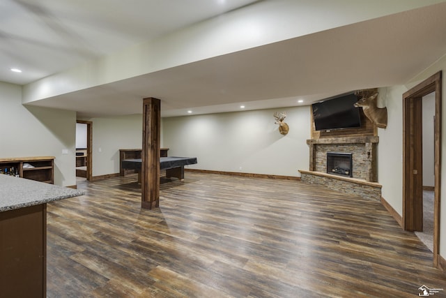 living room featuring a fireplace and dark hardwood / wood-style flooring