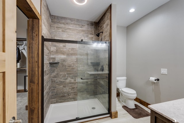 bathroom with vanity, an enclosed shower, and toilet