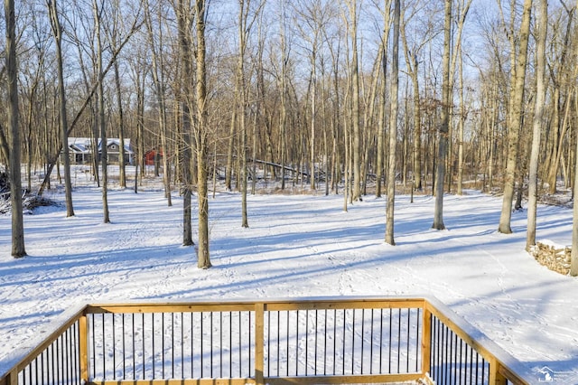 snowy yard featuring a deck