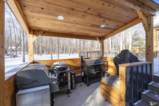 snow covered patio with a grill