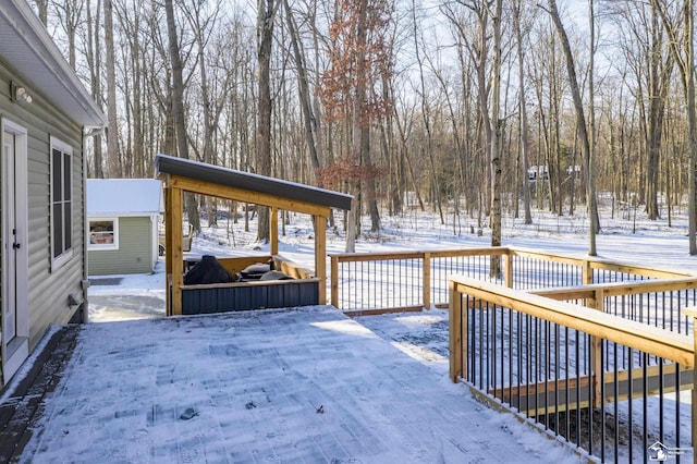 snow covered deck with an outbuilding