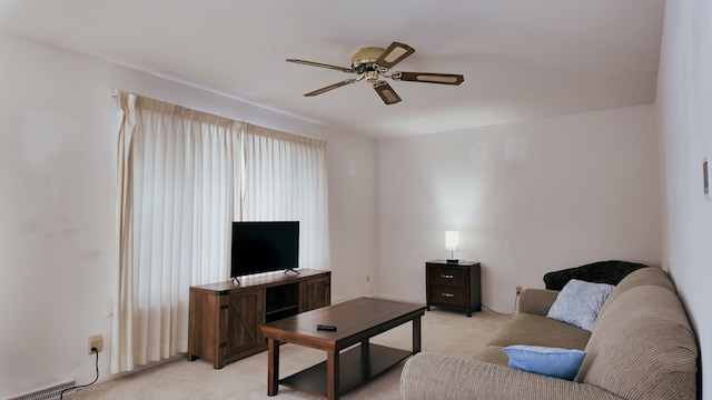 living room featuring light carpet and ceiling fan