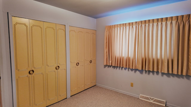 unfurnished bedroom with two closets