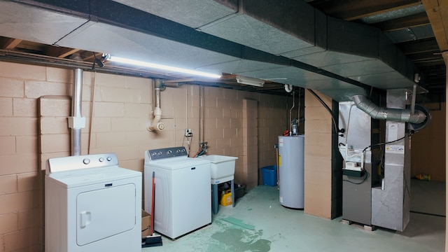 basement with heating unit, independent washer and dryer, sink, and water heater