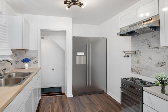 kitchen with stainless steel refrigerator with ice dispenser, sink, gas stove, backsplash, and white cabinets