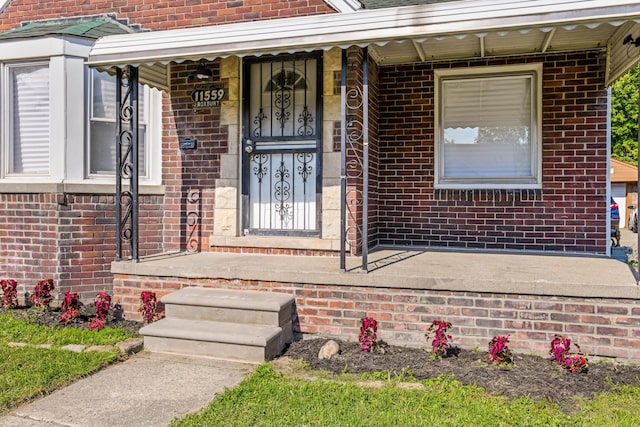 view of exterior entry with covered porch