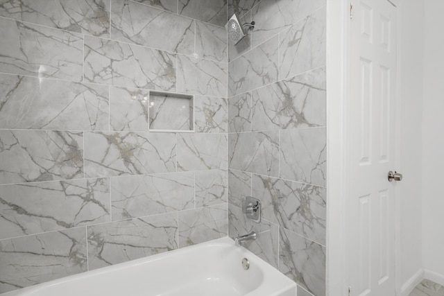 bathroom featuring tiled shower / bath