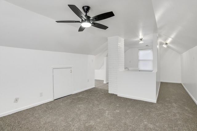 bonus room featuring ceiling fan, vaulted ceiling, and dark colored carpet