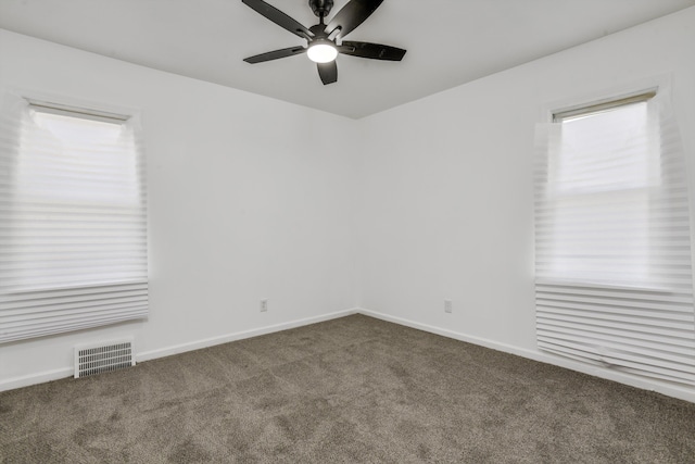 unfurnished room featuring dark colored carpet and ceiling fan