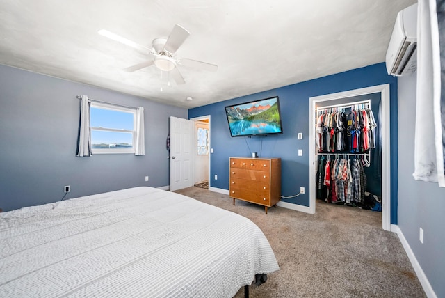 bedroom featuring ceiling fan, carpet flooring, a closet, and an AC wall unit