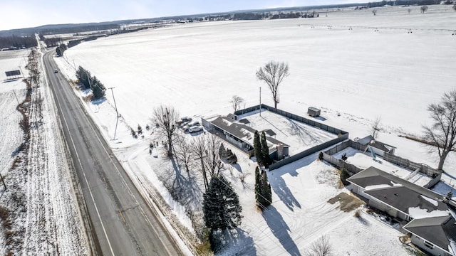 snowy aerial view featuring a rural view