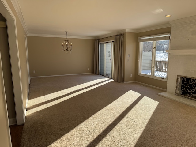 unfurnished living room featuring dark colored carpet, ornamental molding, a brick fireplace, and an inviting chandelier