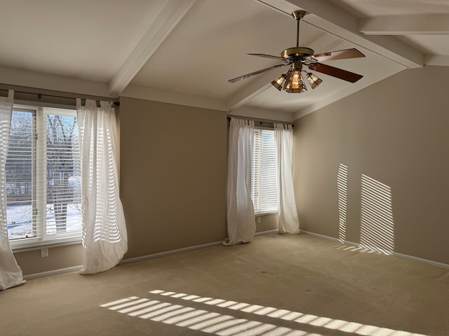 carpeted empty room with ceiling fan and lofted ceiling with beams