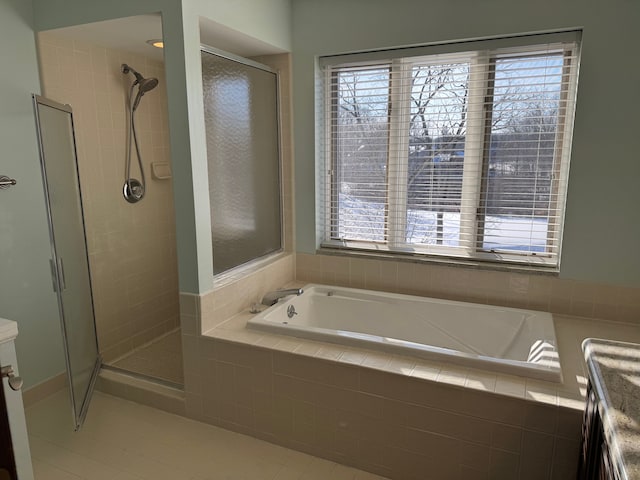 bathroom with plus walk in shower, vanity, and tile patterned floors