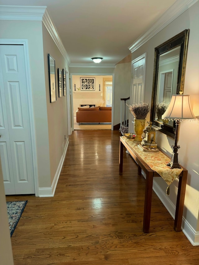 hall with ornamental molding and dark hardwood / wood-style flooring