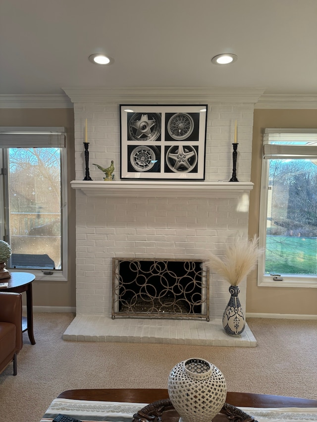 details with crown molding, a brick fireplace, and carpet floors