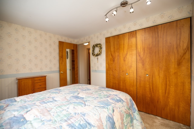 bedroom with light carpet and a closet