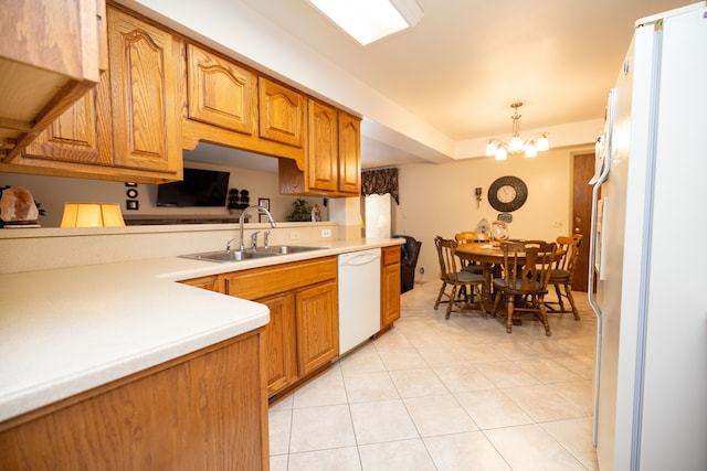 kitchen featuring pendant lighting, sink, white appliances, an inviting chandelier, and light tile patterned flooring