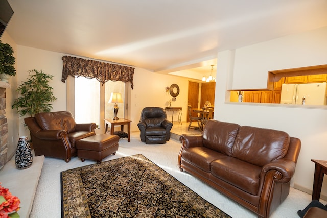 living room with light carpet and an inviting chandelier