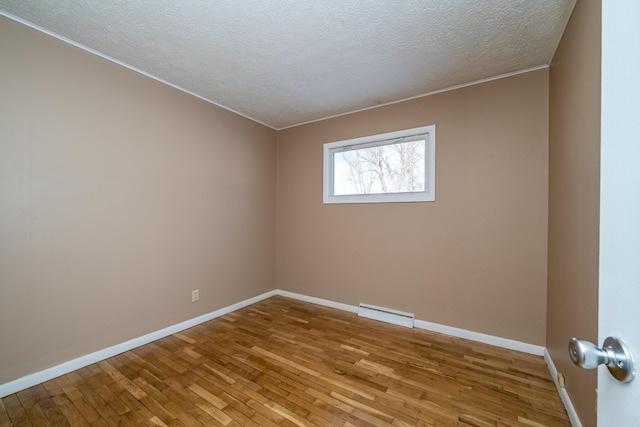 unfurnished room featuring a textured ceiling and light wood-type flooring