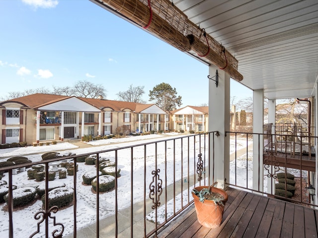 view of snow covered back of property