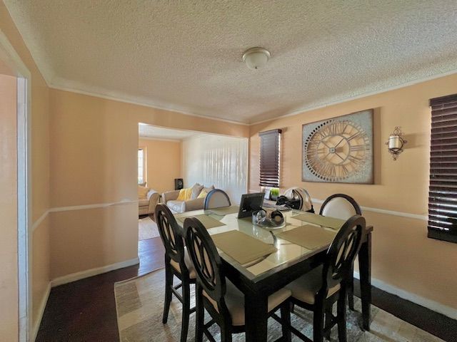 dining area featuring a textured ceiling