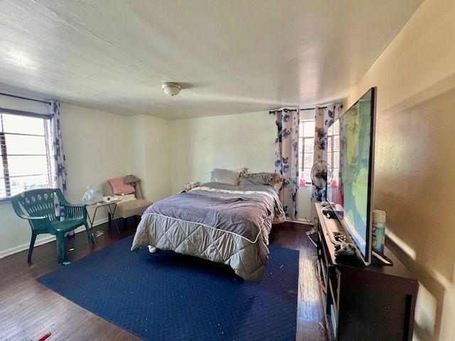 bedroom featuring dark wood-type flooring