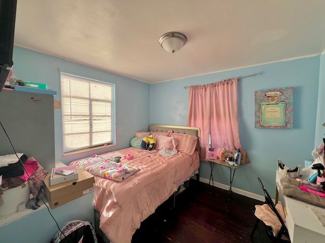 bedroom featuring dark hardwood / wood-style flooring