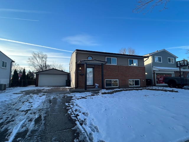 view of front of home with a garage and an outdoor structure