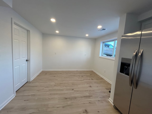 unfurnished dining area featuring light wood-type flooring