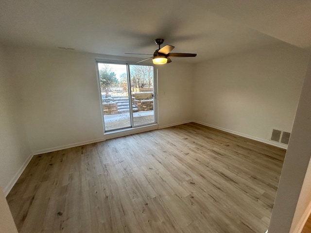 spare room with ceiling fan and light wood-type flooring