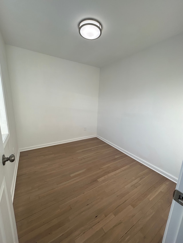 unfurnished room featuring dark hardwood / wood-style floors