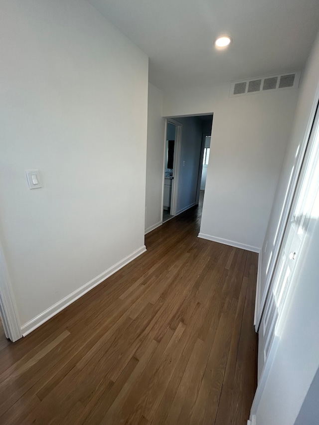 unfurnished room featuring dark hardwood / wood-style flooring