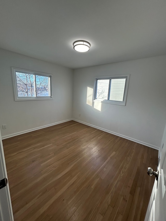 empty room with dark wood-type flooring