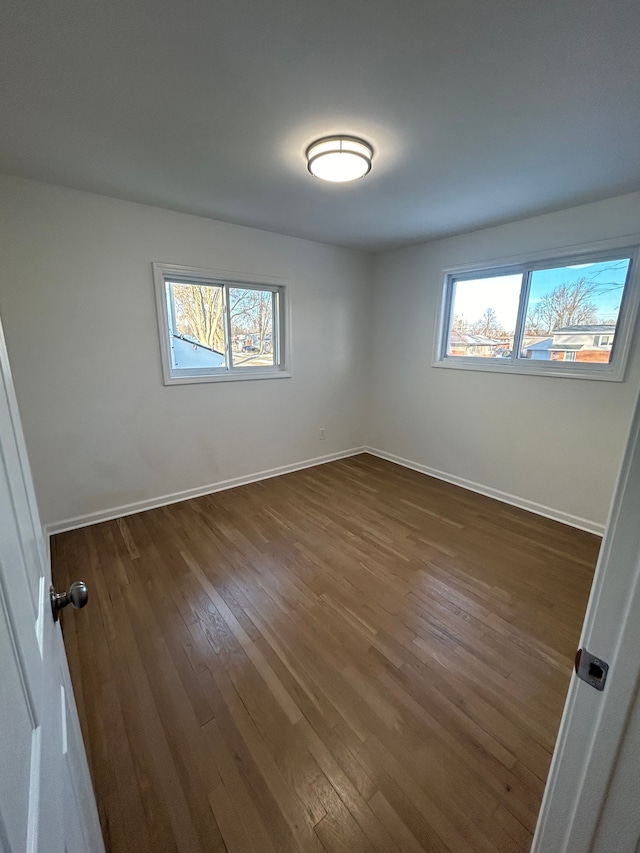 spare room featuring dark hardwood / wood-style floors