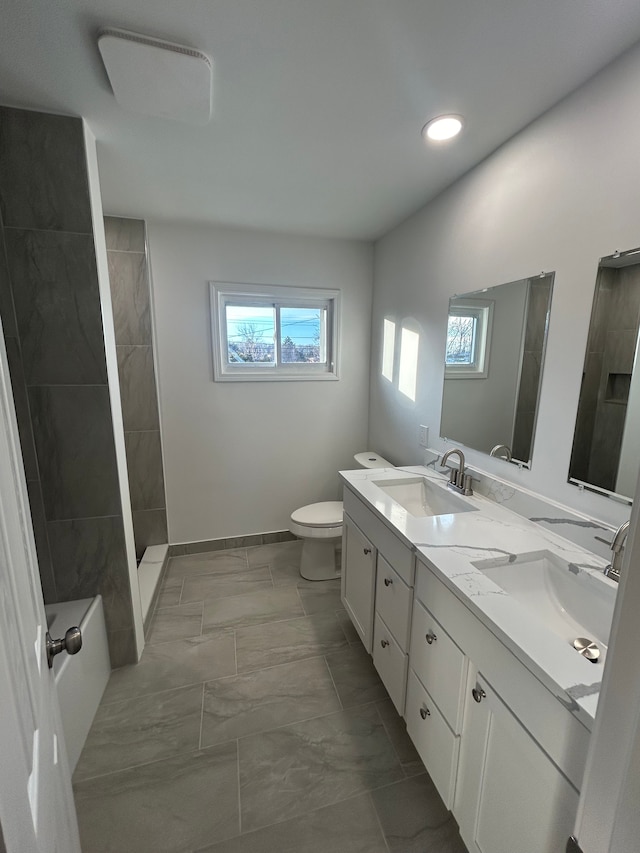 bathroom with vanity, toilet, and a shower