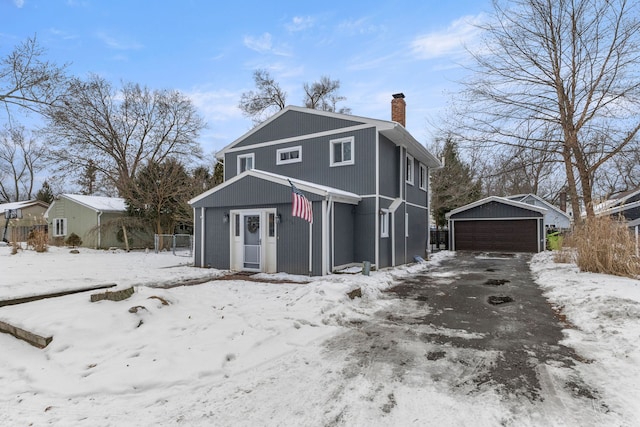 view of front of home with a garage and an outdoor structure