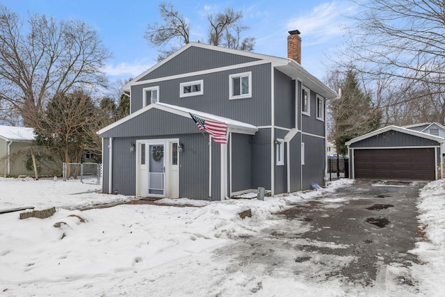 view of property featuring a garage and an outdoor structure